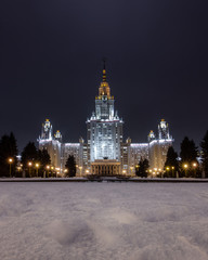 Fototapeta na wymiar Russia, Moscow, Vorobyovy Gory, skyscraper of Moscow State University. Winter landscape, night illumination of the Stalinist skyscraper. Evening walk in the city lights
