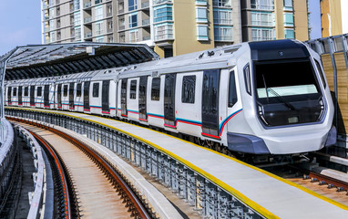 Naklejka premium Malaysia Mass Rapid Transit (MRT) train. People commute with MRT as transportation to work, school, travel, and shopping.
