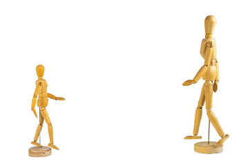 Two wooden mannequins facing each other isolated on white background - social distancing concept