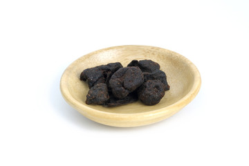 Closeup garcinia cochinchinensis (called Asam kandis in Indonesia) on wooden plate isolated white background