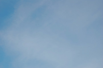 Fantastic soft white clouds against blue sky background, soft focus.