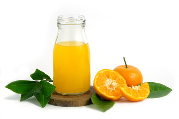 Fresh orange juice above wood coaster, with raw, sliced orange fruit – isolated on white background