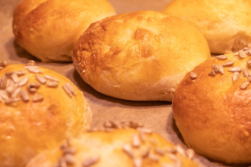Home made bread rolls or buns for breakfast fresh on a paper on a table, selected focus, narrow depth of field