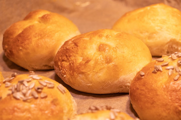 Home made bread rolls or buns for breakfast fresh on a paper on a table, selected focus, narrow...
