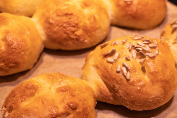 Home made bread rolls or buns for breakfast fresh on a paper on a table, selected focus, narrow...
