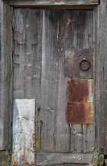 Brown wooden door to the staircase. Old peeling paint