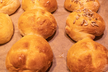 Home made bread rolls or buns for breakfast fresh on a paper on a table, selected focus, narrow depth of field