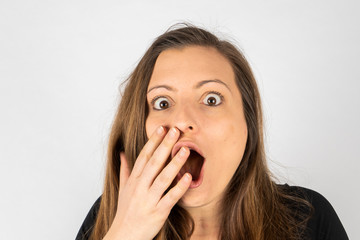 Fototapeta premium Young woman surprised in black shirt with long hair