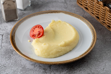 Simple all-purpose garnish: mashed potato puree with a slice of ripe tomato