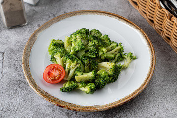 Steamed broccoli as a light dietary garnish in a restaurant