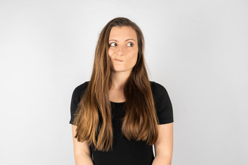 Young woman thinking in black shirt with long hair