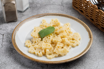 Funny animal shape noodles for kids, boiled and served with butter
