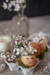 Easter eggs on a plate with gauze and cherry flowers