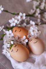 Easter eggs on a plate with gauze and cherry flowers