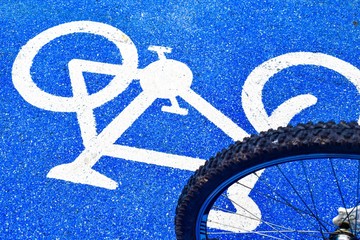 cyclist rides a bike on the lane of bicycle sign