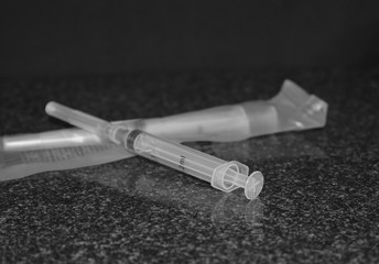syringe on a black background, injection