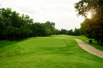 Background of evening golf course has sunlight shining down at golf course in Thailand