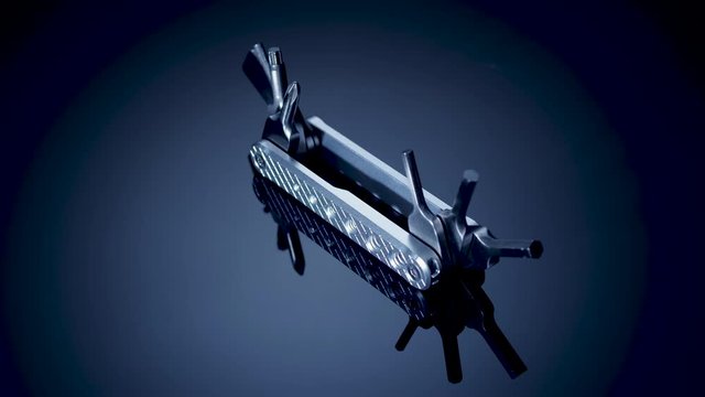 Steel multitool rotation on a black background