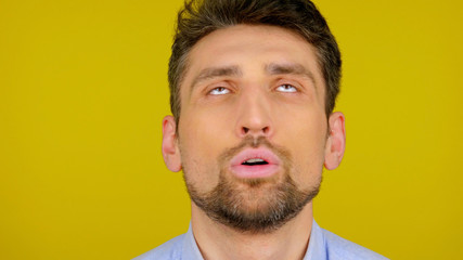 Close-up of the head of a bearded man on a yellow background