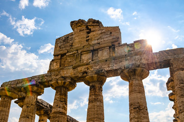 Fototapeta na wymiar Ray of sun through the columns of the Temple of Athena 500 BC. Archaeological site of Paestum