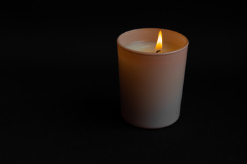 Obraz na płótnie Canvas Glowing rose candle on dark black background