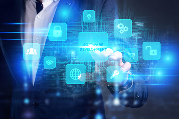 Business, Technology, Internet and network concept. Young businessman working on a virtual screen of the future and sees the inscription: Software development