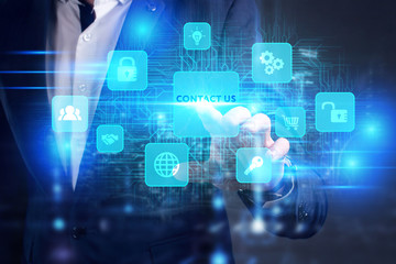 Business, Technology, Internet and network concept. Young businessman working on a virtual screen of the future and sees the inscription: Contact us