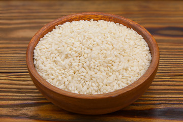 Raw rice groats for risotto on  plate