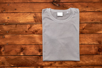 Gray t-shirt on wooden background