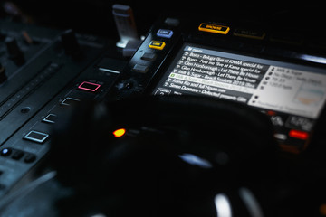dj controller with tracks playlist on screen