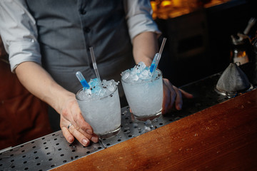 cropped shot of barman preparing cocktails