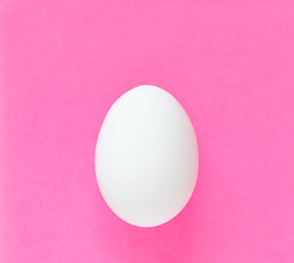 Easter egg on colorful bright pink background