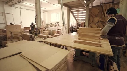 woodworking workshop with workers and machine tools