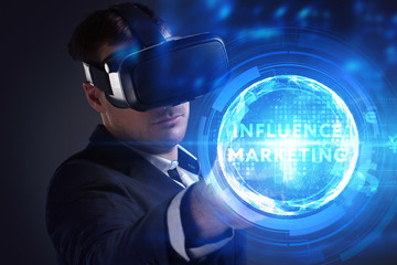 Business, Technology, Internet and network concept. Young businessman working on a virtual screen of the future and sees the inscription: Influence marketing