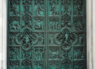 Detail bronze bas-reliefs from main door a Cathedral. Christian background.