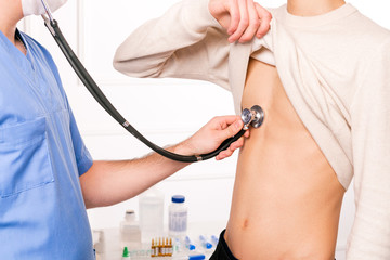 Cheking lungs for pneomonia, coronavirus and covid19 infection. Male doctor with stethoscope...