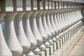 The white marble pillars of the fence close up. Duplicate posts in the future.