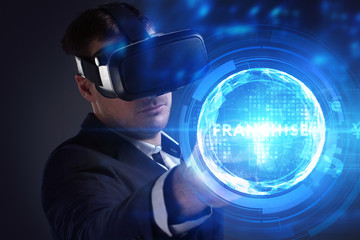 Business, Technology, Internet and network concept. Young businessman working on a virtual screen of the future and sees the inscription: Franchise