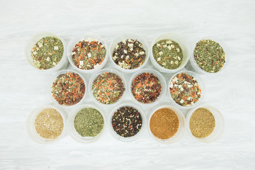 jars with spices on a white table