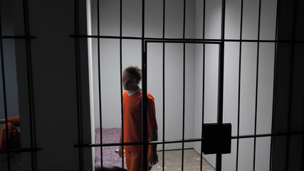 Prisoner walks in a circle in a prison cell