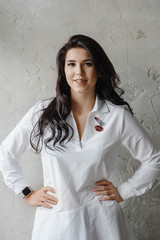 Fashion luxury lady in shirt. Photography of a Attractive girl. Beauty woman in white shirt posing in grey studio. Trendy portrait of seductive sexy girl model in underwear.