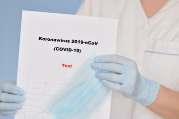 Nurse with COVID-19 test result.