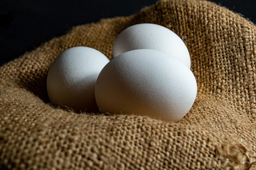 Three egg in sack with black background