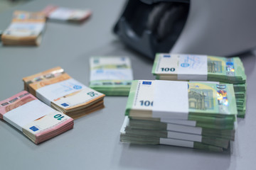 Bundles of banknotes divided into groups with currency straps placed on the electronic counting machine