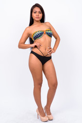 Young Asian woman wearing swimwear against white background