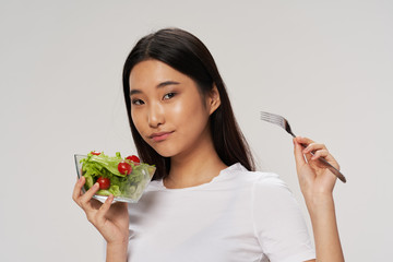 young woman eating salad