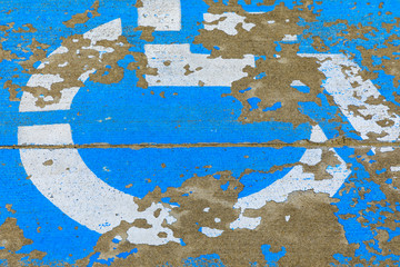 Weathered handicapped parking spot close up - transportation infrastructure road markings