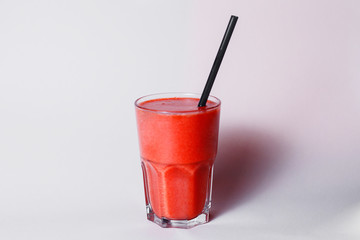 glass cup of strawberry smoothie with straw on studio background best