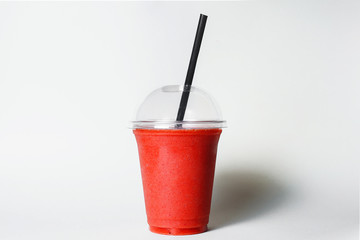 disposable cup of strawberry smoothie with straw on studio background best