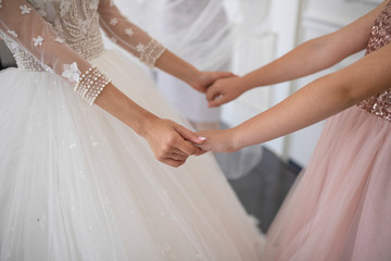 Hands of mom and daughter on the wedding day